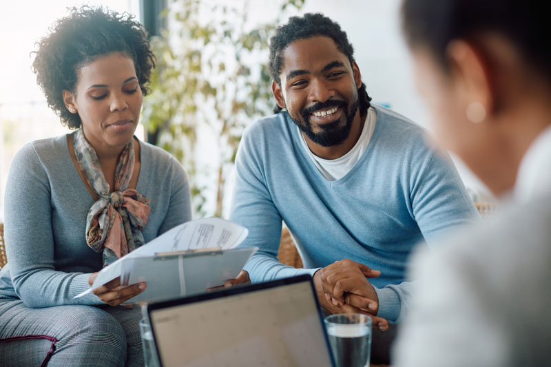 couple getting a loan and signing papers